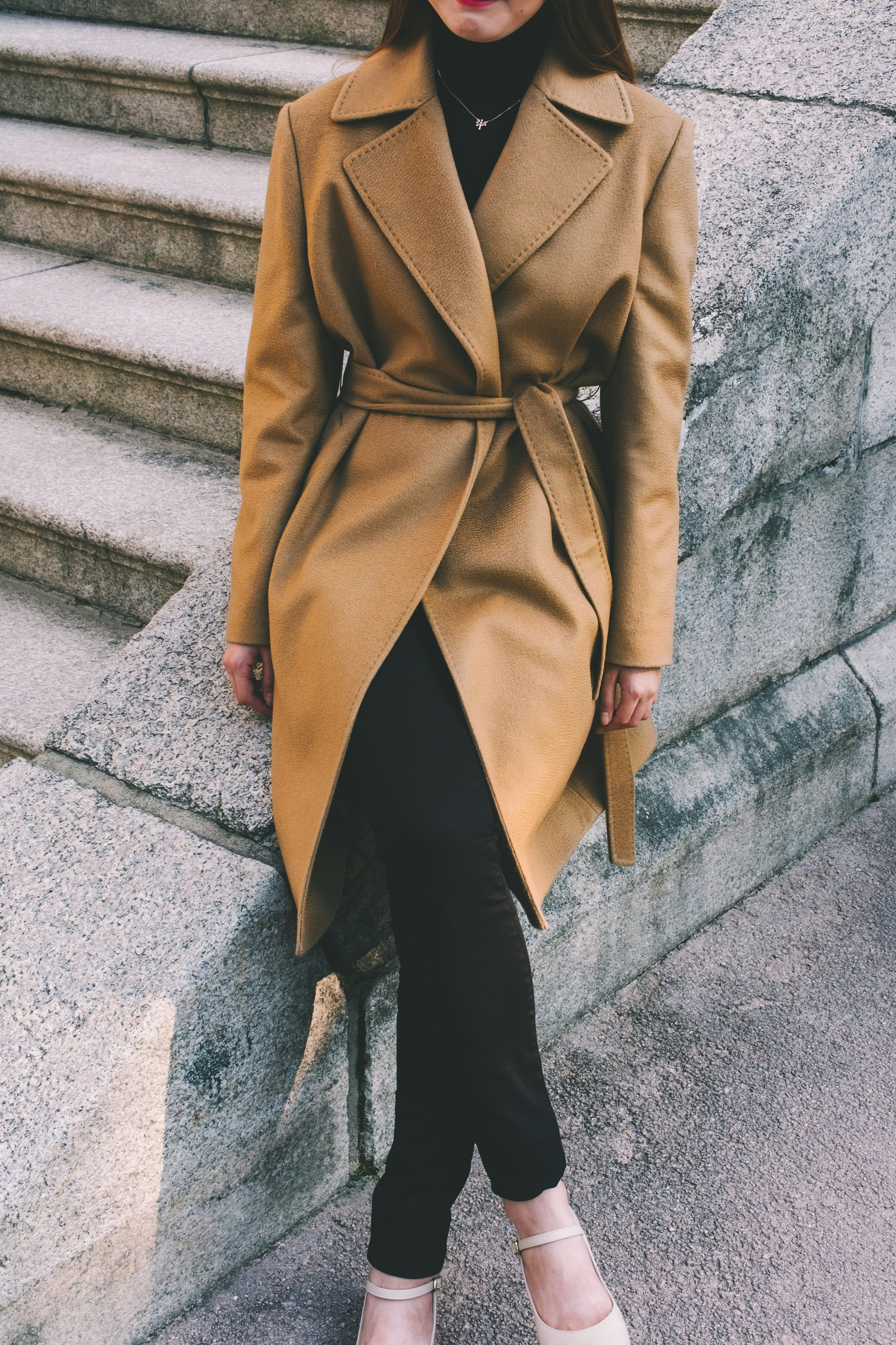 woman wearing brown notched lapel coat